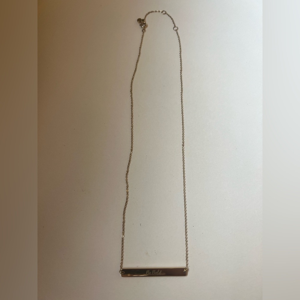 Gold Bar Pendant Necklace with writing on bar saying Be Bold
